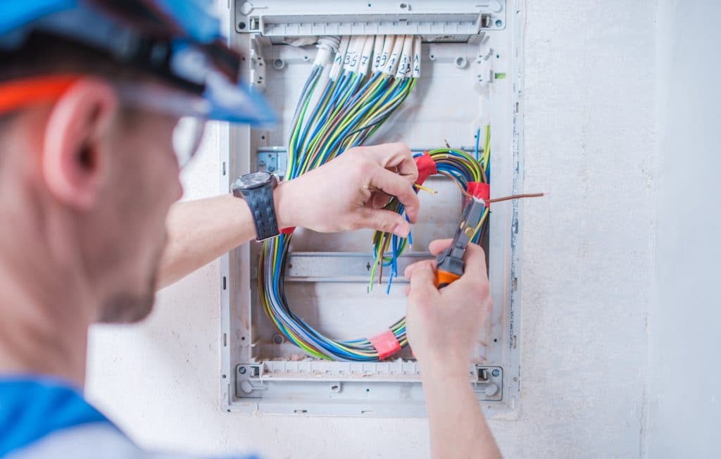 electrician working on a circuit breaker box