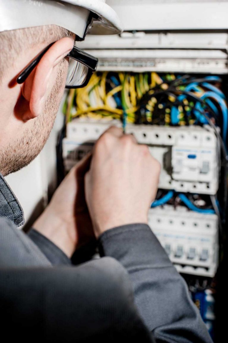 Electrician is fixing the loose wiring in the electric panel