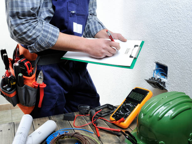 Electrician taking notes while working