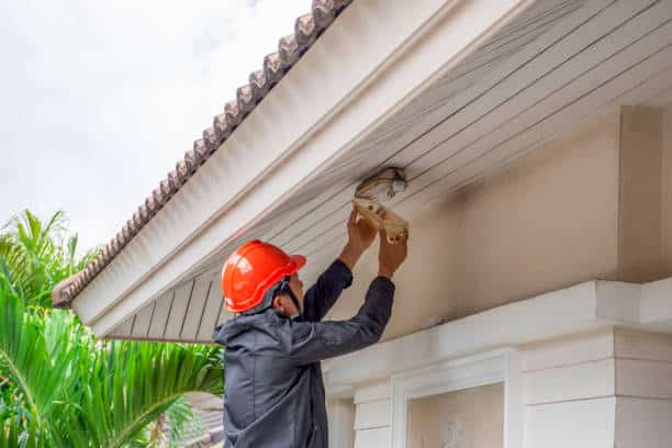 Electrician man working on exterior  light, install LED replacement lamp at home. Outdoor lightning concept 