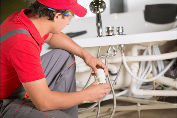 Plumber fixing the bathroom sink. 