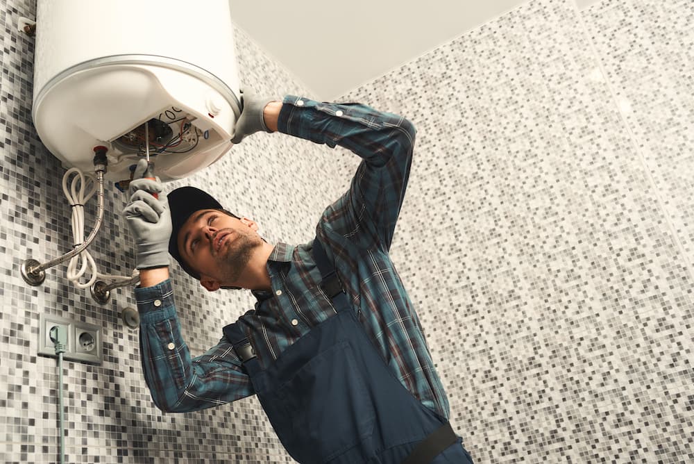 Professional plumbing services in Brooklyn installing new  water heater.