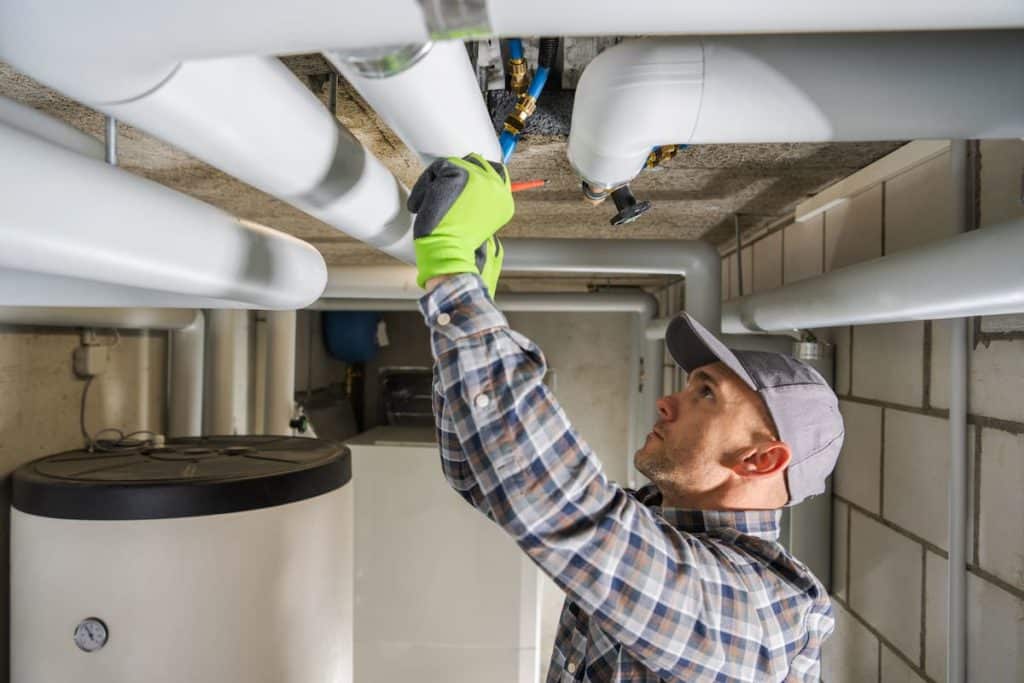 Professional Plumber fixing a leaky pipeline.