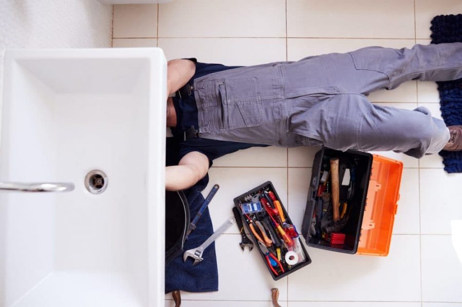 plumber working on a residential bathroom sink