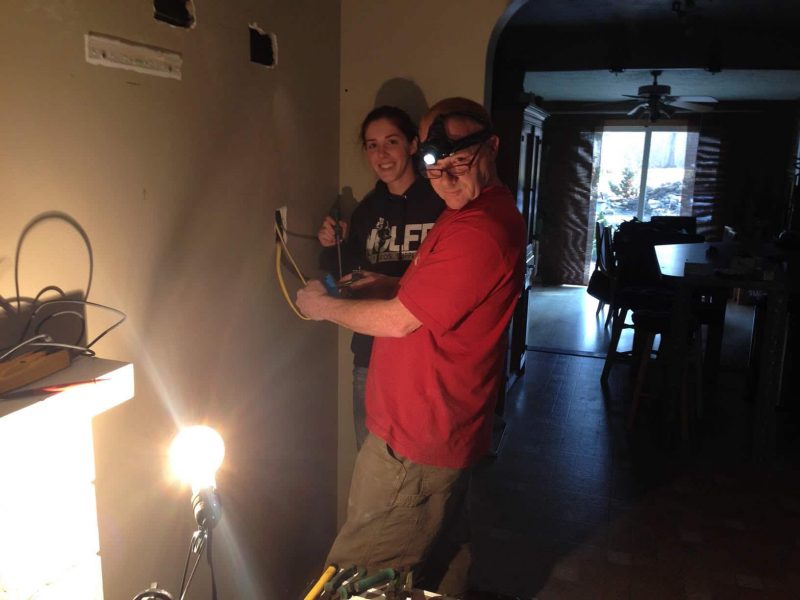 father and daughter doing home electrical troubleshooting